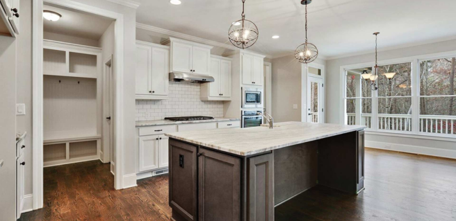custom kitchens with large kitchen island, pendant lighting and large pantry