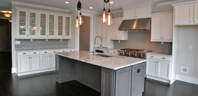 white cabinetry and large kitchen island with pendant lighting